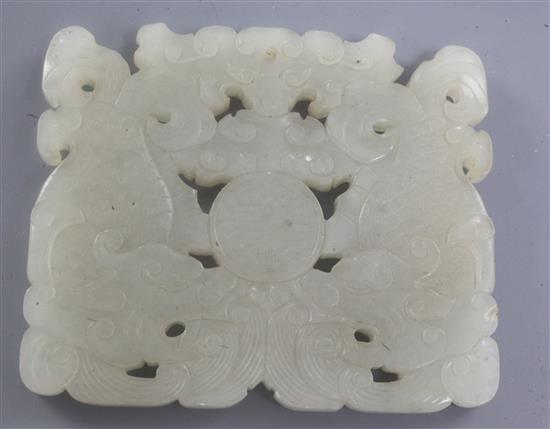 A Chinese white jade plaque, 18th / 19th century, 6.7cm, later wood stand